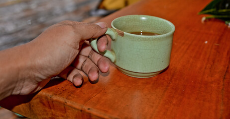 close up view of coffee cup on brown table