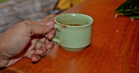 close up view of coffee cup on brown table