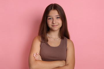Fototapeta premium Portrait of teenage girl on pink background