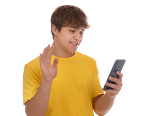 Smiling teenage boy with smartphone waving hello on white background