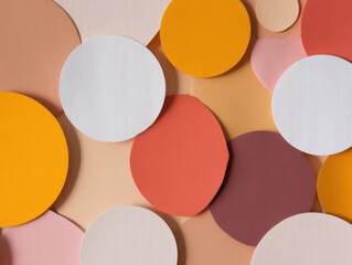 Abstract composition of overlapping colorful circles in warm tones including white, orange, red, pink, and beige on a textured background.
