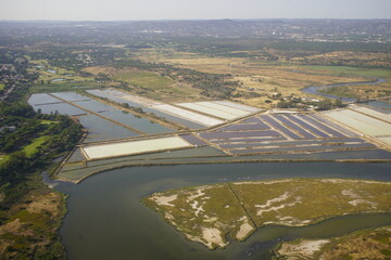 The Ria Formosa in Portugal features traditional sea salt production in shallow pools called 