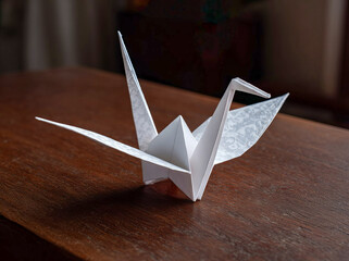 Origami Crane on Wooden Table.