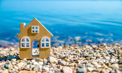 The symbol of the house standing on the seashore
