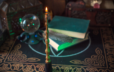 Magical books on a table, magic candle wand, concept of fairy tales
