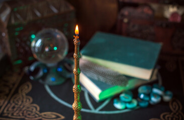 Magical books on a table, magic candle wand, concept of fairy tales