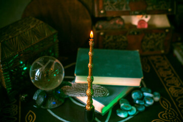 Magical books on a table, magic candle wand, concept of fairy tales
