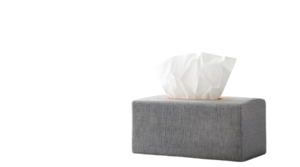 A box of tissues with white tissues sticking out against a black background in a studio shot