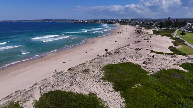 Sydney, Australia -UHD Video-Drone flyover view from Wanda Beach Reserve in Cronulla with beautiful beaches and great surf, but at the same time a sensitive environment with migrating sand dunes.