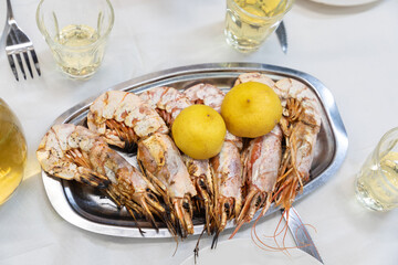 The taste of the Mediterranean - crispy fried shrimps with local white vine on the table