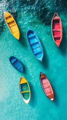 Colorful Rowboats Floating on Turquoise Water. Top-down view of multiple colorful wooden rowboats floating on crystal-clear turquoise sea water.

