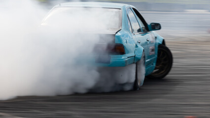 Car drifting, Blurred image diffusion race drift car with lots of smoke from burning tires on speed track, Car drifting on speed track, Professional driver drive drifting car.
