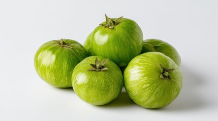 Pile of Fresh Green Zebra Heirloom Tomatoes on White Surface Close Up