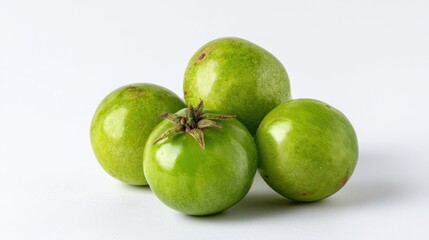 Vibrant green tomatoes still life against seamless clean white backdrop