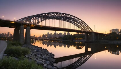 Arch bridge spans a calm river reflecting city skyline at twilight
