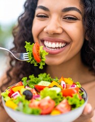 Close-up of a woman enjoying a colorful salad, with focus on her smiling mouth and forkful of fresh vegetables. A vibrant and healthy eating concept perfect for lifestyle, wellness, or nutrition theme