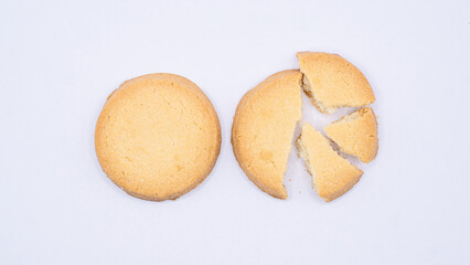 Whole and Broken Round Cookie on White Surface