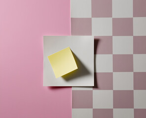 Blank squared paper sheet clipped with metal binder against white background in minimalist office stationery flat lay

