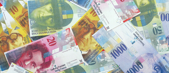 Swiss franc banknotes. The current francs money bills lies on table