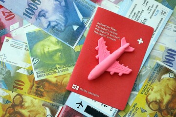 Swiss franc banknotes and passport with tickets. The current francs money bills and biometrical pass
