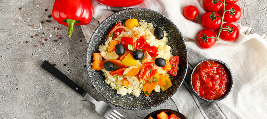 Plate with couscous and vegetables on grunge background