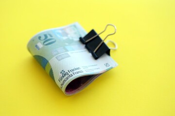 Swiss franc banknotes on yellow background. The current francs money bills lies in big amount