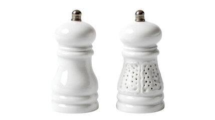 A pair of white ceramic salt and pepper shakers with silver tops on a dark background in a studio shot