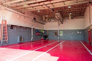 Empty bay at fire station with red floor