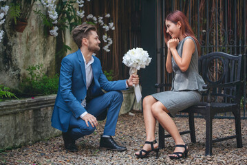 Surprise proposal young couple lover boyfriend give flower Bouquet to beautiful girlfriend to will...