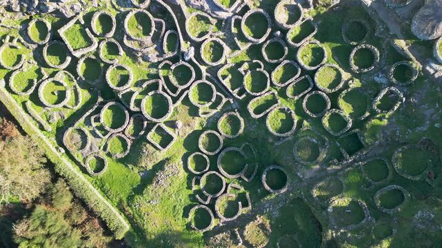 Aerial view of ancient ruins in green landscape, Spain.