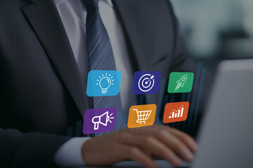 Businessman using laptop with digital marketing icons and growth chart
