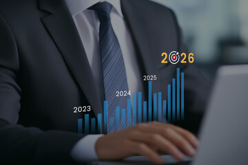 Businessman analyzing financial growth chart towards 2026 target