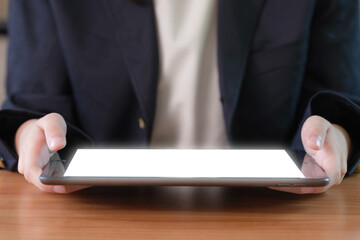 Close-up image of a businesswoman's hand using a digital tablet.