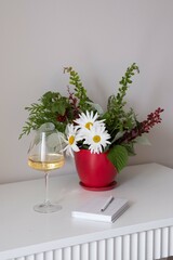 An Elegant Floral Arrangement with Wine Placed in a Modern, Inviting Setting for Gathering