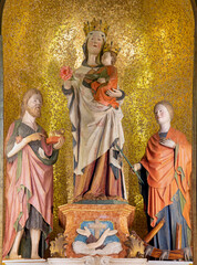 PIACENZA, ITALY - MAY 19, 2025: The carved polychrome statue of Madonna, St. John Baptist and St....