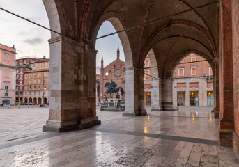 Piacenza - The square Piazza Cavalli under the porticoes fo Palazzo Comunale with the church Chiesa...