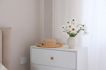 The Charming Daisy Arrangement beautifully enhances a Cozy Living Room, creating an inviting vibe