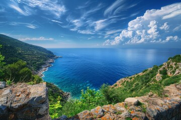 Breathtaking view of elba island's coastline, featuring crystal clear turquoise waters under a vibrant blue sky with dramatic clouds
