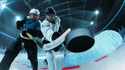 Two ice hockey players battling for puck control, showcasing intensity and focus in motion on 3D...