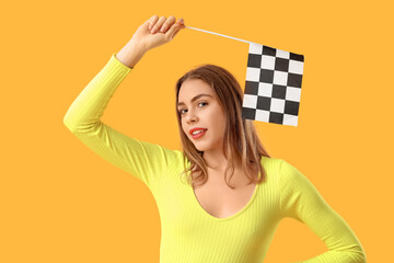 Beautiful young woman with racing flag on yellow background