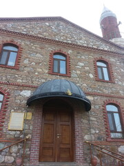 The entrance of a mosque in the Ottoman architectural style, built with historical stone and brick...