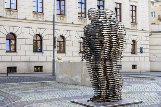 Poznan, Poland - June 18, 2025: Golema David Cerny, a striking kinetic layered metal sculpture, stands prominently in an urban setting, symbolizing modern public art