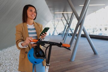 Young Asian woman riding an electric scooter
