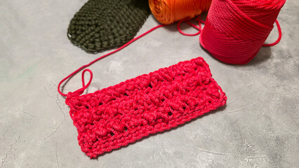 Pattern for knitting a bag. Crocheted from polyester cord. On a gray background