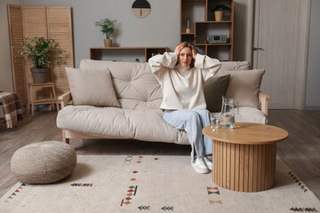 Adult woman suffering from headache at home