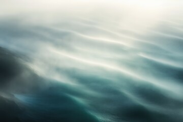 Ocean waves moving in soft focus with mist covering water surface, creating abstract seascape with gentle motion and blurred lines, no people or objects visible in scene