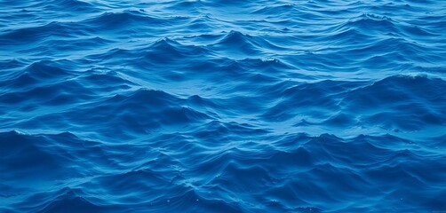 Fototapeta premium Abstract deep blue ocean waves texture, calming sea background, dynamic, gradation