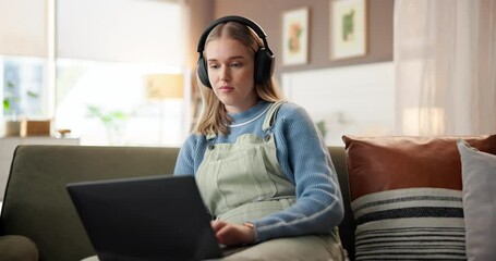 Education, laptop and music with woman on sofa in living room of home for online course or study. Computer, headphones and remote learning with college student in apartment for university scholarship - Powered by Adobe