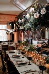 Elegant wedding reception table with floral arrangement and candles