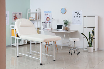 Interior of ophthalmologist's office with workplace and couch